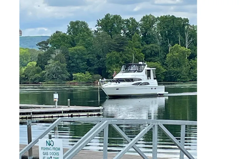 Slide: The Image of 2005 Carver 444 Cockpit Motor Yacht on a tranquil lake. - 2