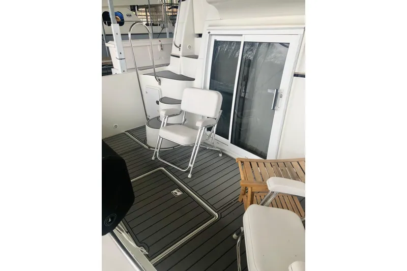 Slide: The Image of 2005 Carver 444 Cockpit Motor Yacht interior with chairs and sliding glass door. - 22