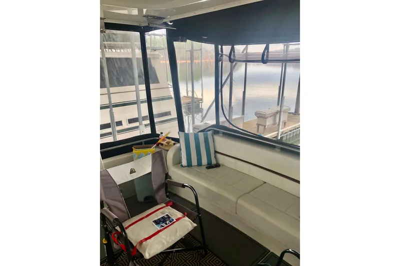 Slide: The Image of 2005 Carver 444 Cockpit Motor Yacht interior with seating and lake view. - 25