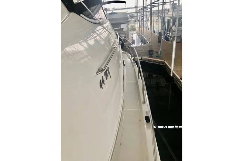 Slide: The Image of 2005 Carver 444 Cockpit Motor Yacht docked in marina, side view. - 29