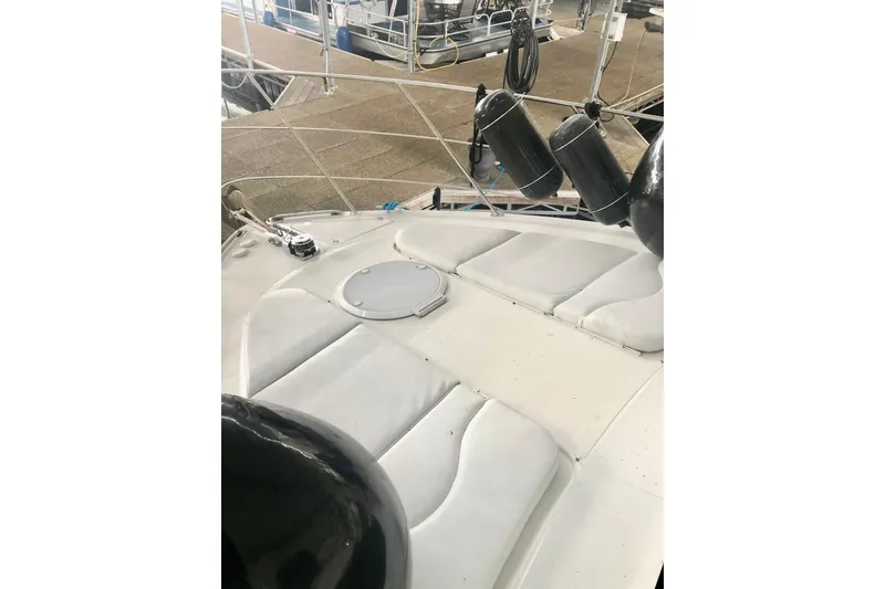 Slide: The Image of 2005 Carver 444 Cockpit Motor Yacht with cushioned seating and dock view. - 33