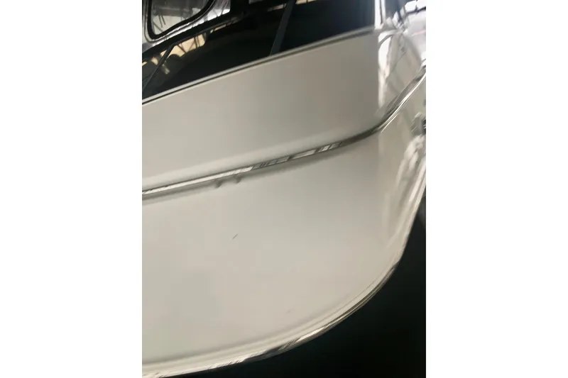 Slide: The Image of 2005 Carver 444 Cockpit Motor Yacht, close-up view of the sleek white exterior. - 34