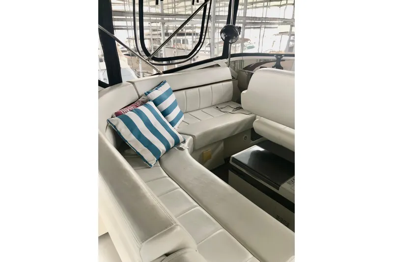 Slide: The Image of 2005 Carver 444 Cockpit Motor Yacht interior with white seating and striped cushions. - 37