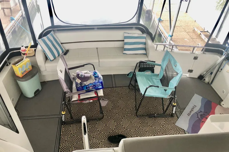 Slide: The Image of 2005 Carver 444 Cockpit Motor Yacht interior with seating and striped cushions. - 46