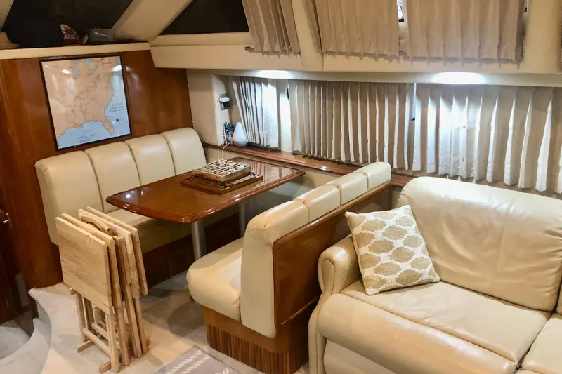 Slide: The Image of Luxurious interior of 2005 Carver 444 Cockpit Motor Yacht with dining area and seating. - 51