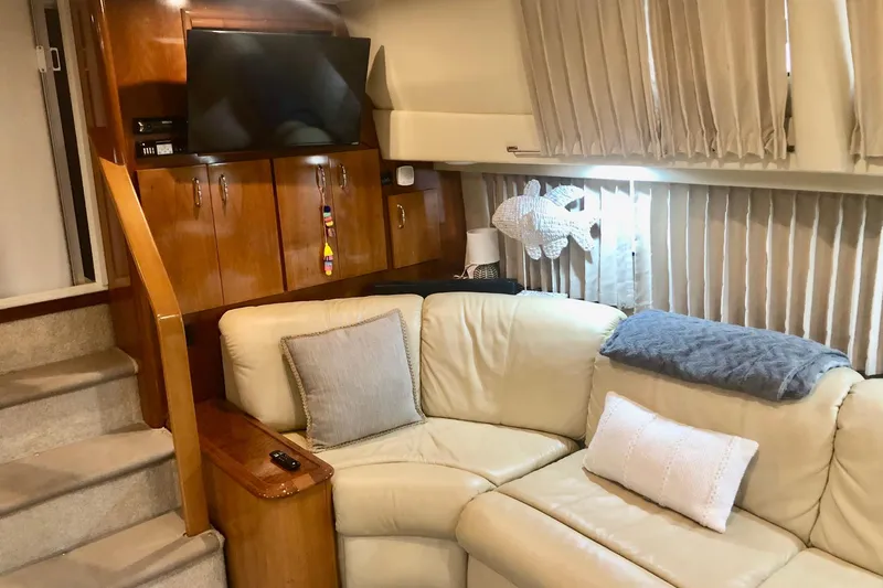 Slide: The Image of Interior of 2005 Carver 444 Cockpit Motor Yacht with cozy seating and TV. - 53