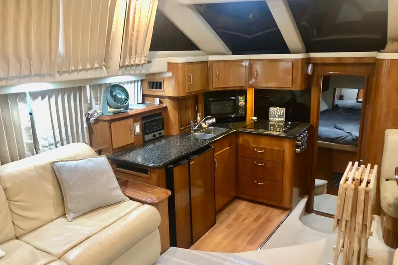 Slide: The Image of Luxurious interior of 2005 Carver 444 Cockpit Motor Yacht with modern kitchen and cozy seating. - 55