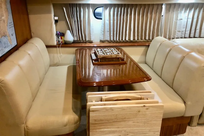 Slide: The Image of Luxurious interior of 2005 Carver 444 Cockpit Motor Yacht with elegant dining area. - 56