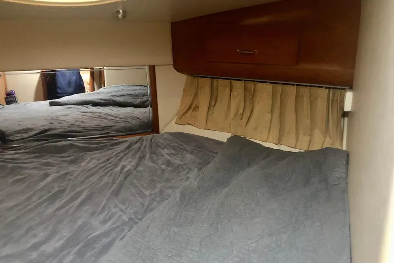 Slide: The Image of Interior cabin of 2005 Carver 444 Cockpit Motor Yacht with bed and wooden cabinetry. - 61
