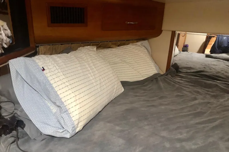 Slide: The Image of Cozy bedroom interior of 2005 Carver 444 Cockpit Motor Yacht with pillows and bedding. - 62