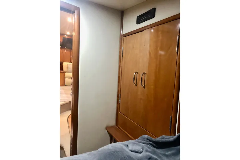 Slide: The Image of Interior of 2005 Carver 444 Cockpit Motor Yacht with wooden cabinetry and cozy bedroom. - 63