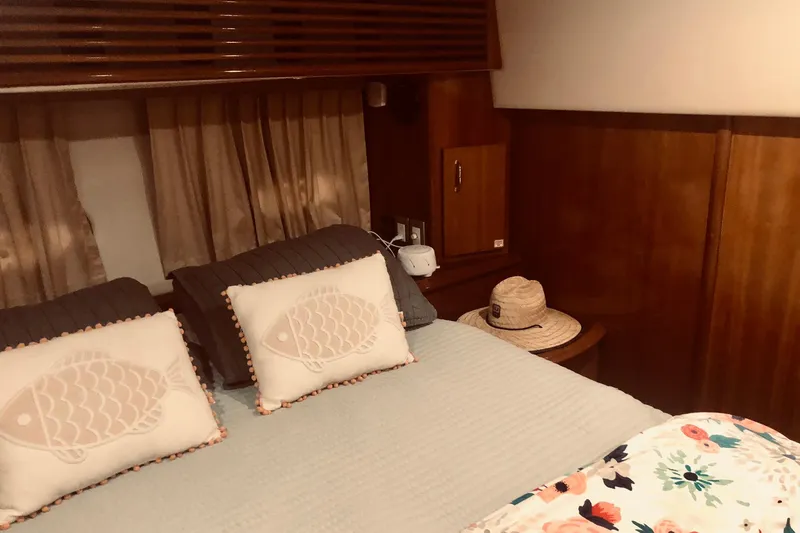 Slide: The Image of 2005 Carver 444 Cockpit Motor Yacht bedroom with cozy bedding and decorative pillows. - 68