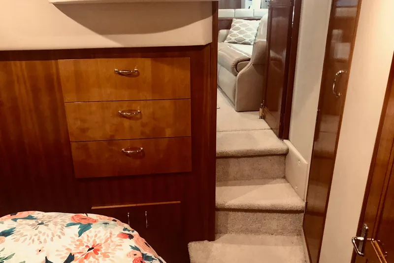 Slide: The Image of Interior of 2005 Carver 444 Cockpit Motor Yacht with wooden cabinetry and carpeted steps. - 69