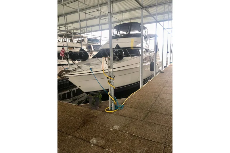 Slide: The Image of 2005 Carver 444 Cockpit Motor Yacht docked in a covered marina. - 7