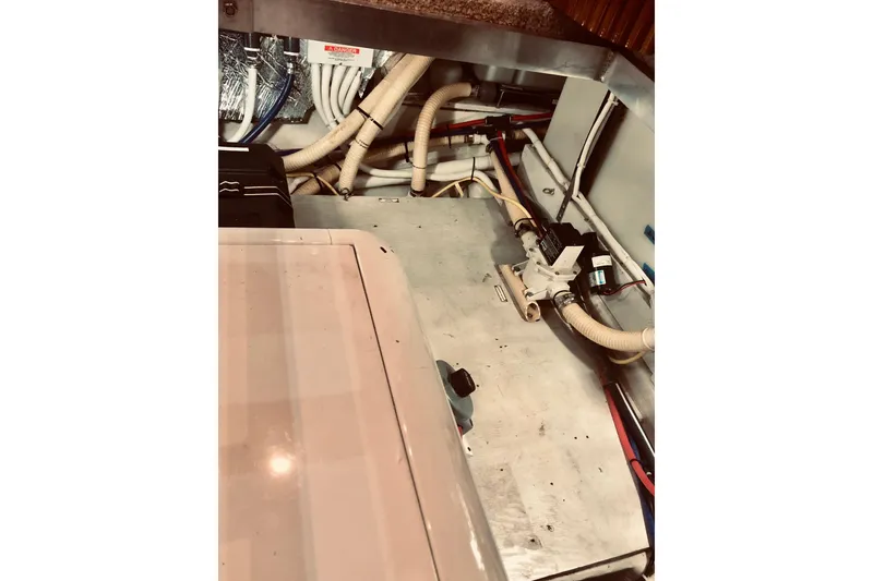 Slide: The Image of Engine room of 2005 Carver 444 Cockpit Motor Yacht with visible piping and equipment. - 75