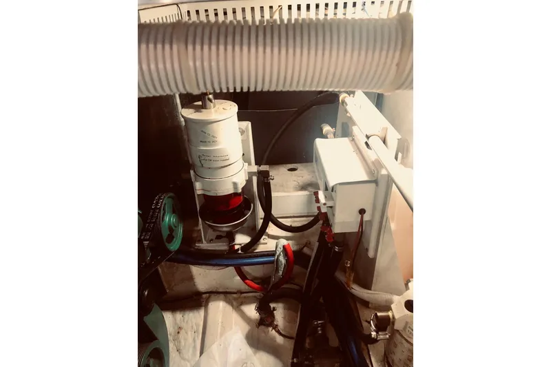 Slide: The Image of Engine compartment of 2005 Carver 444 Cockpit Motor Yacht, showcasing mechanical components. - 80