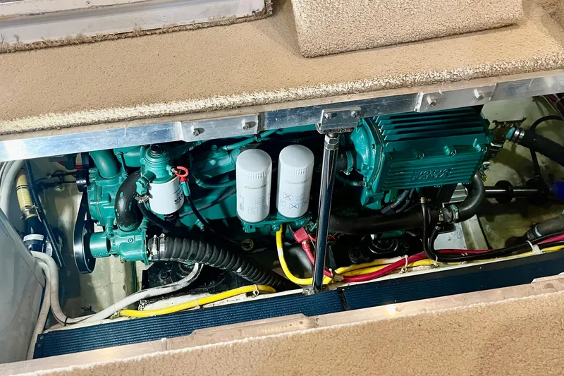 Slide: The Image of Engine compartment of a 2005 Carver 444 Cockpit Motor Yacht, showcasing mechanical components. - 83
