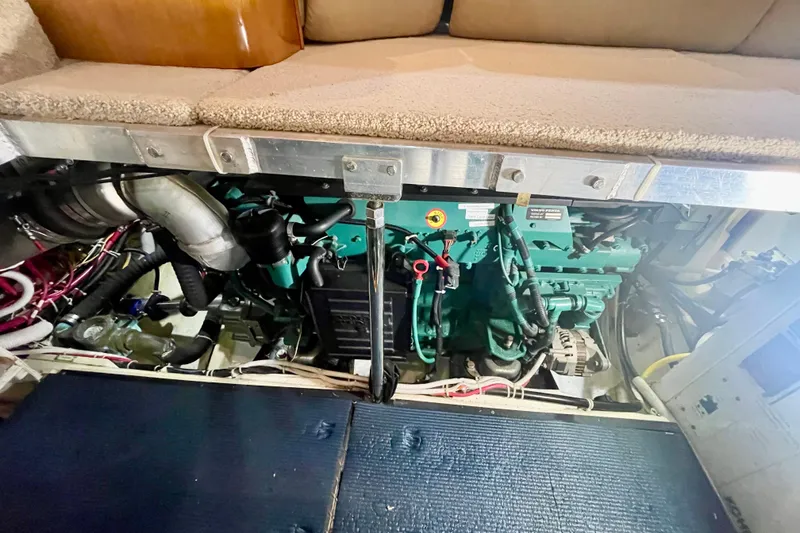 Slide: The Image of Engine compartment of 2005 Carver 444 Cockpit Motor Yacht, showcasing mechanical components. - 84