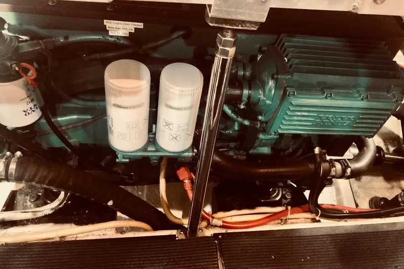 Slide: The Image of Engine compartment of 2005 Carver 444 Cockpit Motor Yacht with visible filters and components. - 85