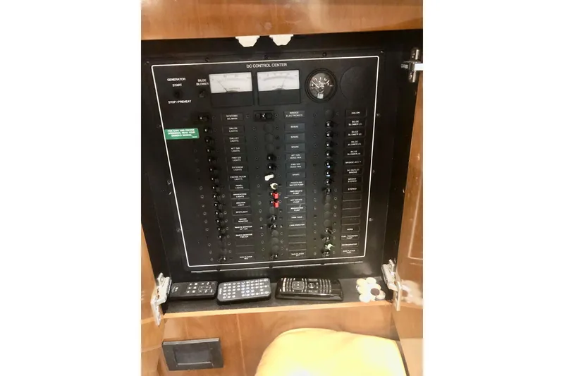 Slide: The Image of Control panel of 2005 Carver 444 Cockpit Motor Yacht with various switches and meters. - 88