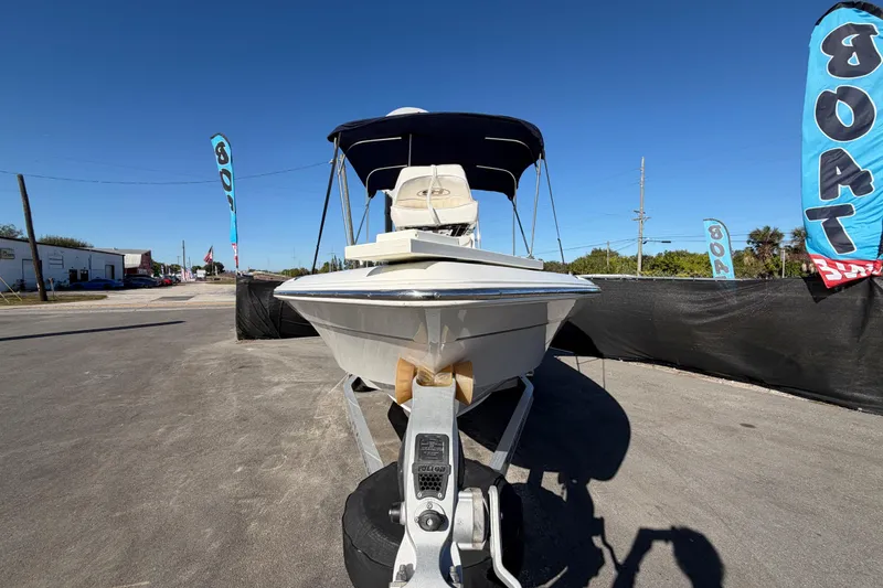 Slide: The Image of 2013 Sea Hunt XP 19 boat on trailer, displayed outdoors with blue sky background. - 11