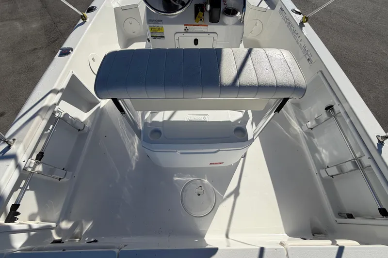 Slide: The Image of 2013 Sea Hunt XP 19 boat interior with seating and storage compartments. - 16