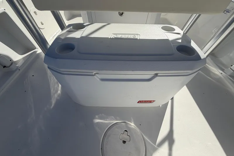 Slide: The Image of White Coleman cooler on 2013 Sea Hunt XP 19 boat deck. - 18