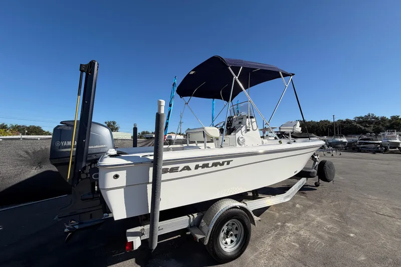 Slide: The Image of 2013 Sea Hunt XP 19 boat on trailer, blue sky. - 2