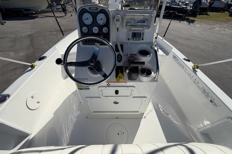 Slide: The Image of 2013 Sea Hunt XP 19 boat cockpit with steering wheel and control panel. - 21