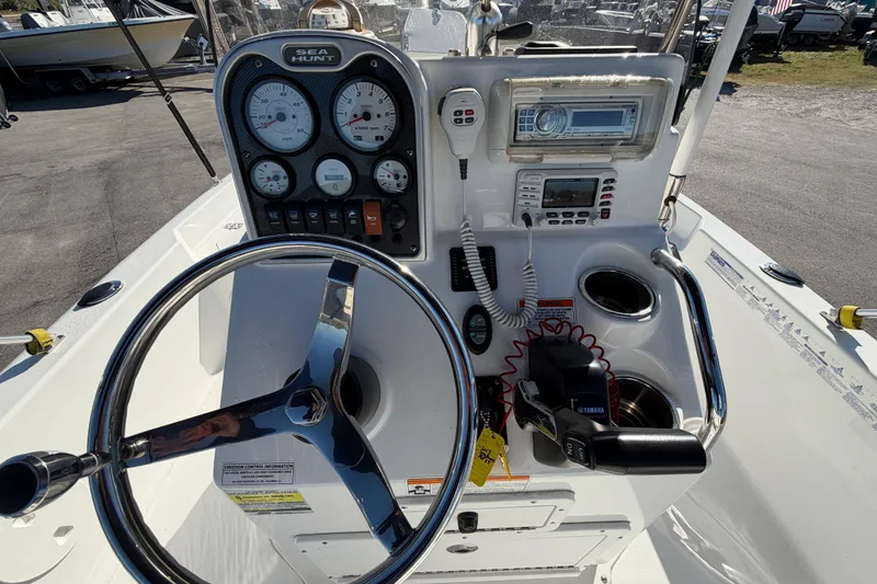 Slide: The Image of 2013 Sea Hunt XP 19 boat dashboard with steering wheel and control panel. - 22