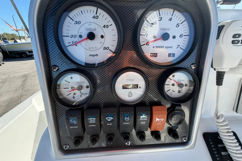 Slide: The Image of Dashboard of a 2013 Sea Hunt XP 19 boat with Yamaha gauges and controls. - 23