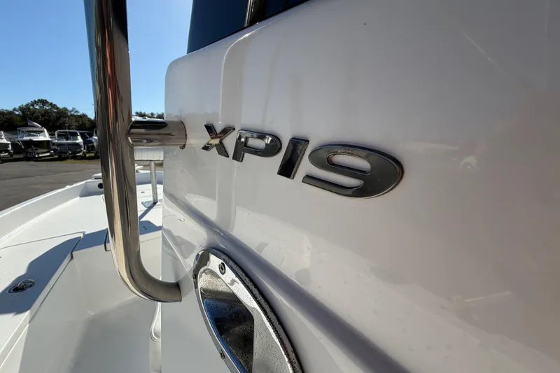 Slide: The Image of 2013 Sea Hunt XP 19 boat, close-up of model name on white hull. - 29