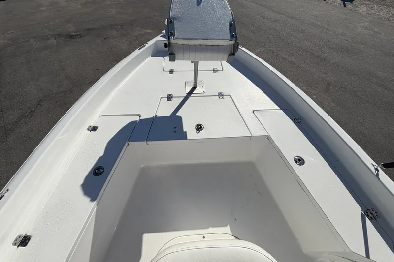 Slide: The Image of 2013 Sea Hunt XP 19 boat deck with seating and storage compartments. - 32
