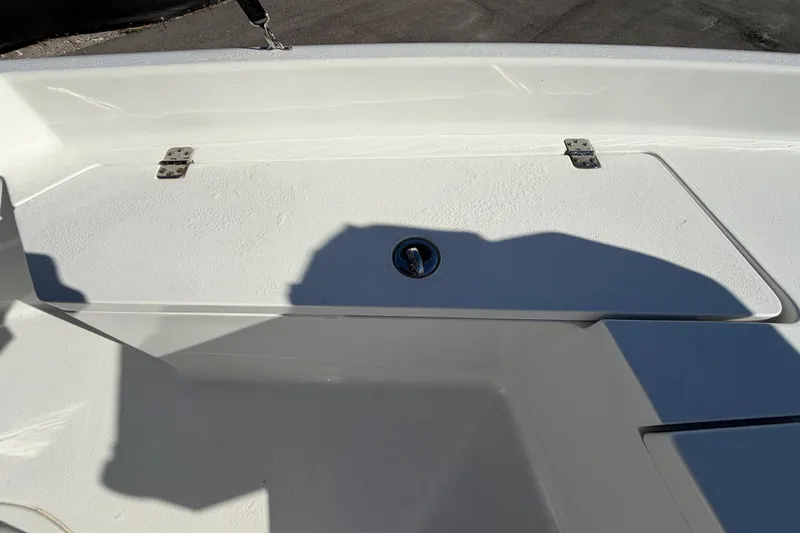 Slide: The Image of 2013 Sea Hunt XP 19 boat deck with storage compartment and latch. - 33