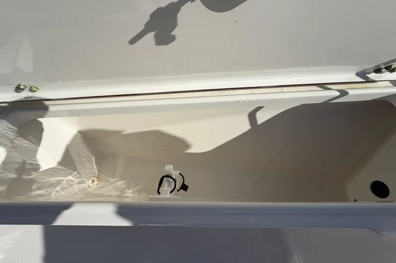 Slide: The Image of Open storage compartment of 2013 Sea Hunt XP 19 boat, showing interior details. - 34