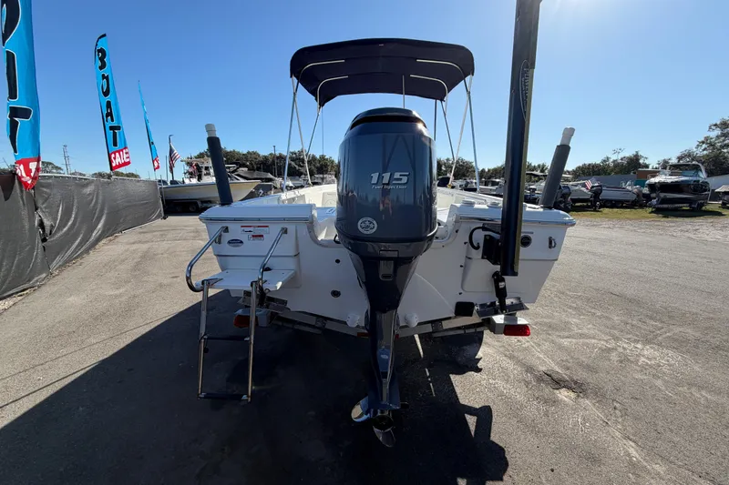 Slide: The Image of 2013 Sea Hunt XP 19 boat with 115 HP engine at a sale event. - 4