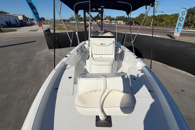 Slide: The Image of 2013 Sea Hunt XP 19 boat with canopy, parked on pavement, ready for sale. - 42