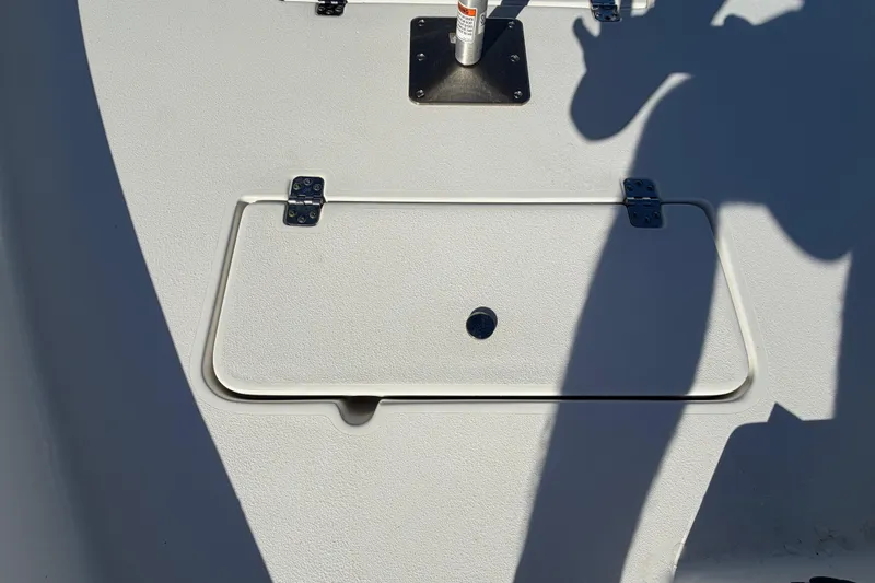 Slide: The Image of 2013 Sea Hunt XP 19 boat deck with storage hatch and shadows. - 44