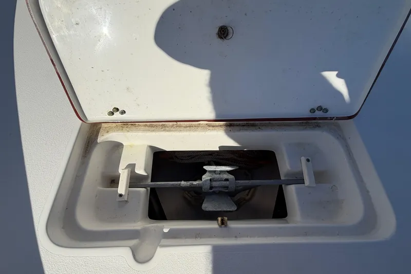 Slide: The Image of 2013 Sea Hunt XP 19 boat anchor compartment with open hatch. - 45