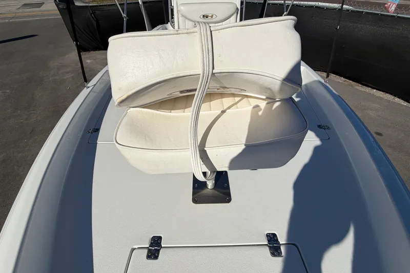 Slide: The Image of 2013 Sea Hunt XP 19 boat with white seating and deck, outdoor setting. - 46