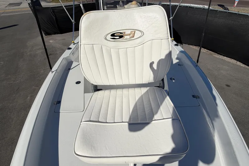 Slide: The Image of 2013 Sea Hunt XP 19 boat with white cushioned seating and SH logo. - 47