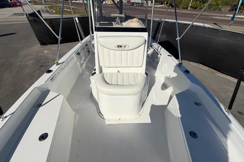 Slide: The Image of 2013 Sea Hunt XP 19 boat interior with white seating and console. - 48