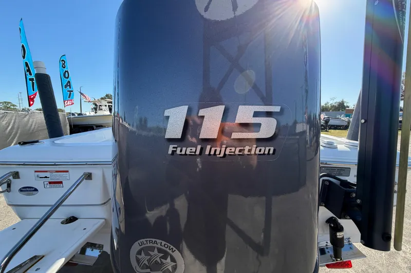 Slide: The Image of 2013 Sea Hunt XP 19 boat with 115 fuel injection engine, displayed at a boat sale. - 5