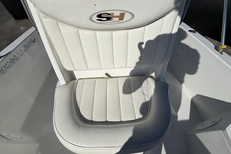 Slide: The Image of White cushioned seat on 2013 Sea Hunt XP 19 boat, featuring SH logo. - 50