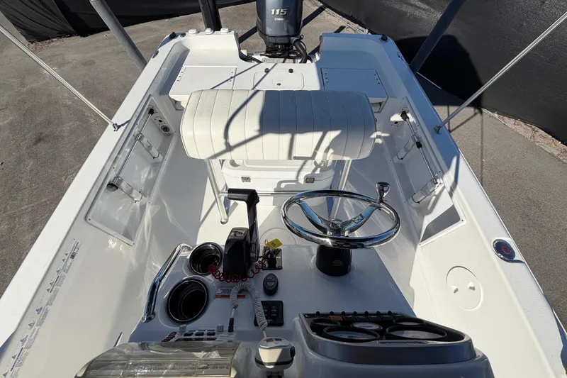 Slide: The Image of 2013 Sea Hunt XP 19 boat cockpit with steering wheel and controls. - 52