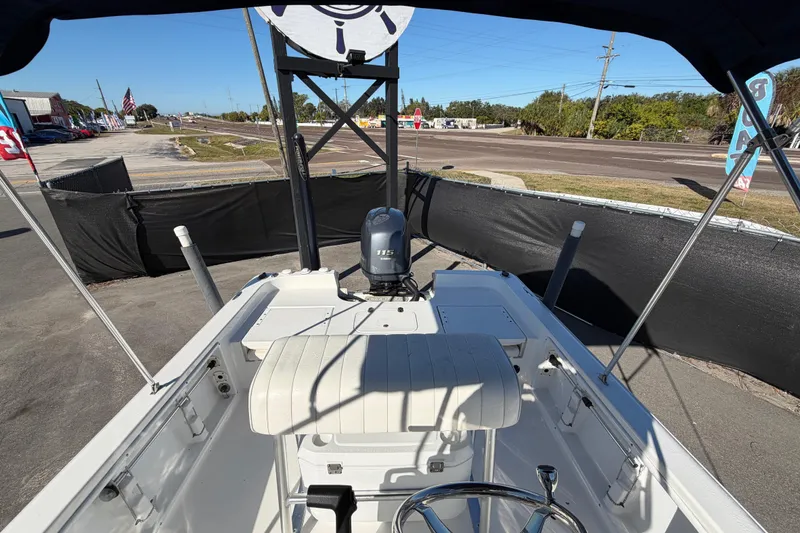 Slide: The Image of 2013 Sea Hunt XP 19 boat interior with steering wheel and outboard motor. - 53