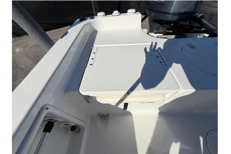 Slide: The Image of 2013 Sea Hunt XP 19 boat interior with storage compartment and engine view. - 55