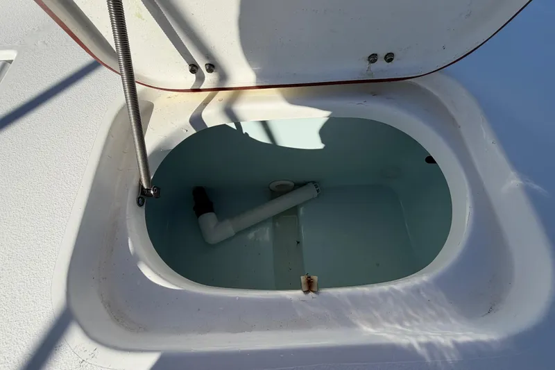 Slide: The Image of Open storage compartment on 2013 Sea Hunt XP 19 boat, showing interior details. - 59