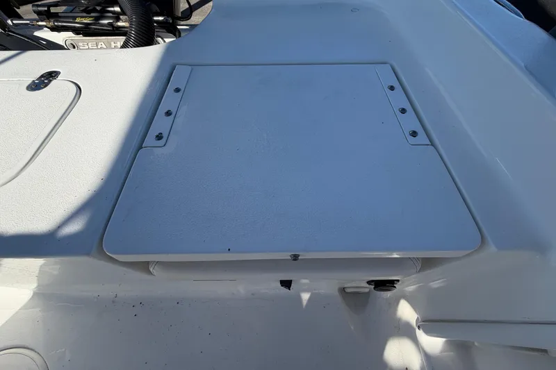 Slide: The Image of 2013 Sea Hunt XP 19 boat deck with storage compartment. - 60