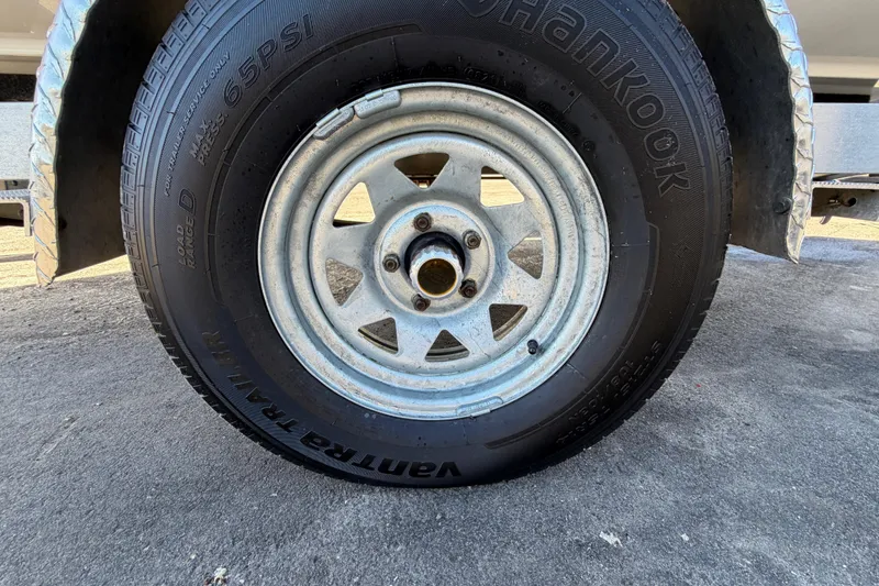 Slide: The Image of Trailer wheel with Hankook tire on a 2013 Sea Hunt XP 19 boat trailer. - 68